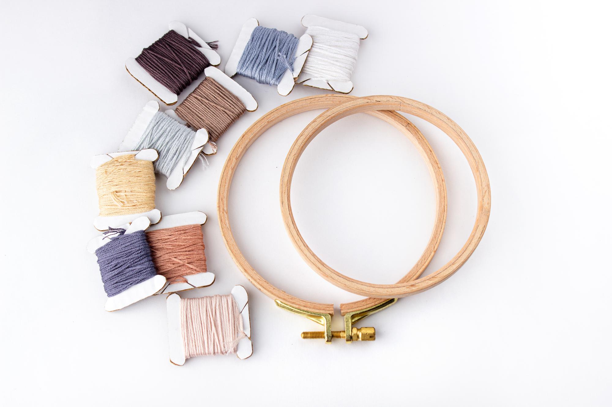 Three embroidery hoops with different projects